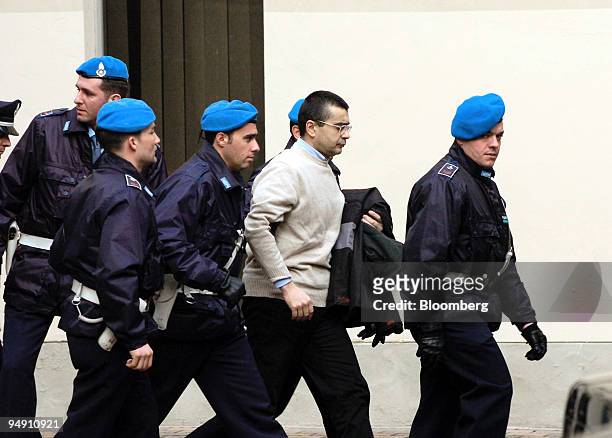 Gianfranco Bocchi, second right, an accountant who worked in Parmalat's accounts office under former chief financial officer Fausto Tonna is escorted...