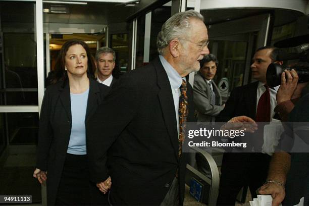 Former Enron Chief Financial Officer Andrew Fastow, rear center, and wife Lea, left, exit the Federal Courthouse in Houston, Texas on January 14,...