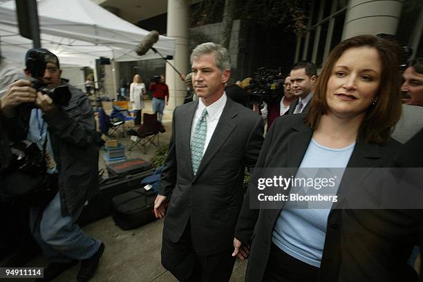 Former Enron Chief Financial Officer Andrew Fastow, center, and wife Lea Fastow, former Enron assistant treasurer, right, exit the Federal Courthouse...