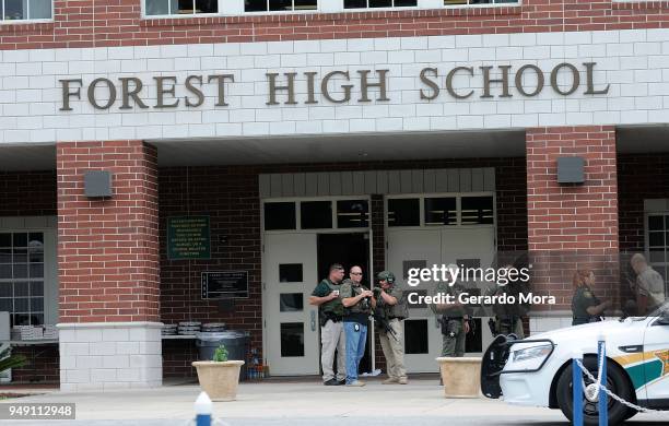 Police officers stand outside Forest High School after a school shooting on April 20, 2018 in Ocala, Florida. It was reported that a former student...