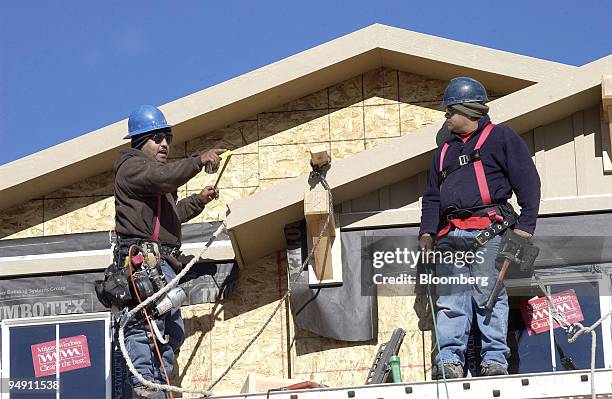 Construction worker build a house in the Highlands Ranch area of Denver, Colorado, January 5, 2004. U.S. Housing starts unexpectedly rose to a 2.088...