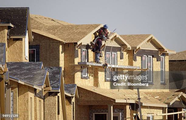 Construction workers build homes in the Highlands Ranch area of Denver, Colorado, January 5, 2004. U.S. Housing starts unexpectedly rose to a 2.088...