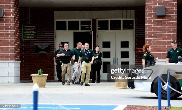 Police officers stand outside Forest High School after a school shooting on April 20, 2018 in Ocala, Florida. It was reported that a former student...