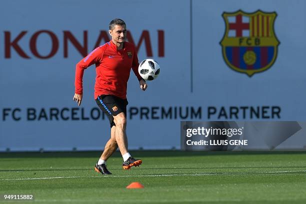 Barcelona's coach Ernesto Valverde takes part in a training session at the Joan Gamper Sports Center in Sant Joan Despi, near Barcelona, on April 20,...