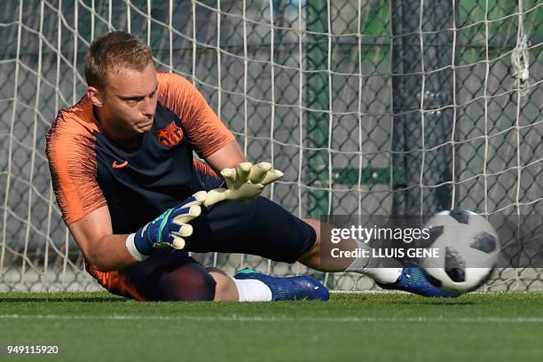 Barcelona's Dutch goalkeeper Jasper Cillessen dives for the ball during a training session at the Joan Gamper Sports Center in Sant Joan Despi, near...