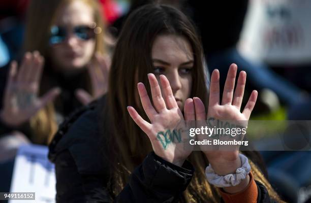 Demonstrator holds out her hands displaying the words "Don't Shoot" during a school walkout protesting the National Rifle Association in Washington,...