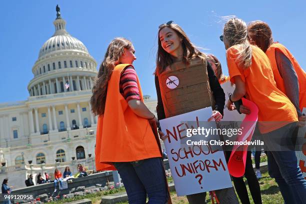 Yorktown High School junior Zoe Coutlakis wears body armor while rallying with several hundred fellow students to call for stricter gun laws on the...