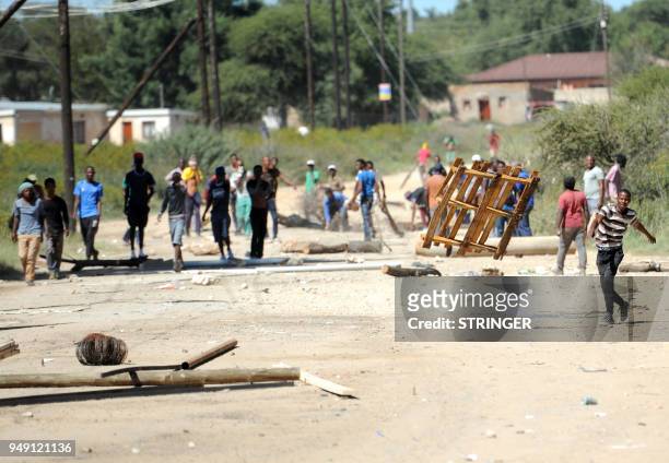 Residents and protesters clash with South African police on April 20 as protest continued for a second day in the northwestern province capital of...