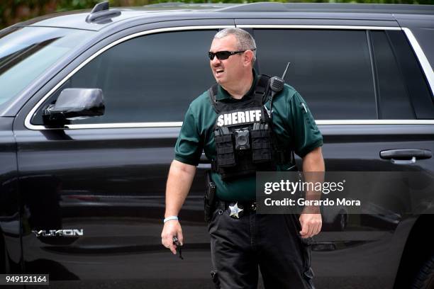 Marion County Police officer walks out Forest High School after a school shooting on April 20, 2018 in Ocala, Florida. It was reported that a former...