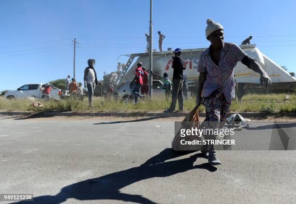 People are pictured after clashes with South African police on April 20 as protest continued for a second day in the northwestern province capital of...