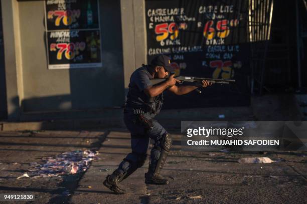 South African riot police fires rubber bullets to prevent looting in North West Province on April 20 as protest continued for a second day in...