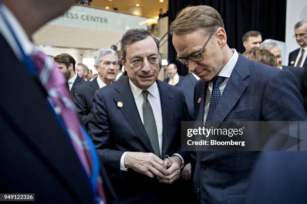 Mario Draghi, president of the European Central Bank , center, talks to Jens Weidmann, president of the Deutsche Bundesbank, after a Group of 20...