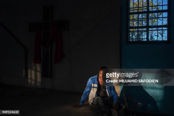 Man is pictured inside looted Ethiopian Gospal Church on April 20 as protest continued for a second day in the South African North West province...
