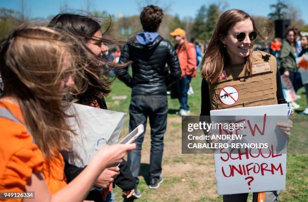 Yorktown High School junior Zoe Coutlakis holds a sign on the West Lawn of the US Capitol after rallying with several hundred fellow students to call...