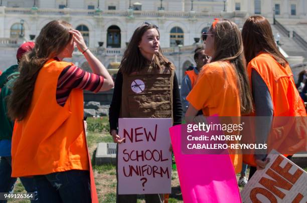 Yorktown High School junior Zoe Coutlakis holds a sign on the West Lawn of the US Capitol after rallying with several hundred fellow students to call...