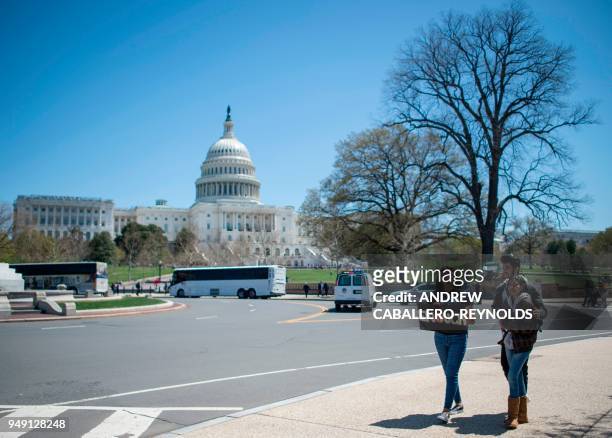 Students walk away from the US Capitol after rallying with several hundred fellow students to call for stricter gun laws in Washington, DC on April...