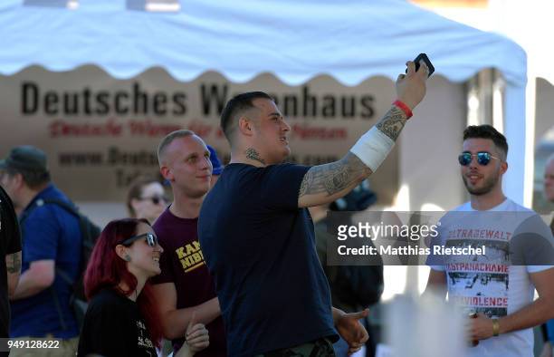 Participant of "Shield and Sword" take a selfie, on April 20, 2018 in Ostritz, Germany. Police are expecting over 1,000 neo-Nazis from Germany,...