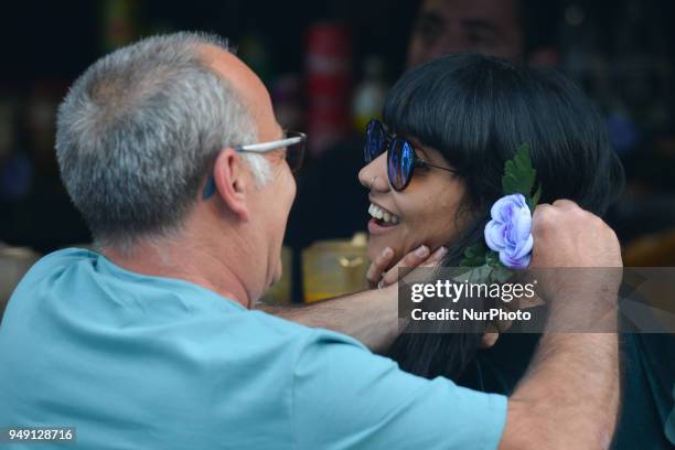 Local lady getting her hear decorated with a flower in the capital of Madeira Island, on day one of the 2018 edition of the Flowers Festival, one of...