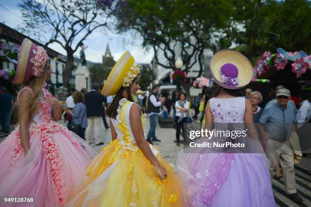 Dream Flowers by Isabel Borges - hostesses wear a hand made floral dresses and hats in the center of Funchal, the capital of Madeira Island, on day...