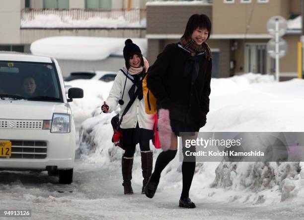 People walk in heavy snow at city center on December 19, 2009 in Yamagata Prefecture, Japan.