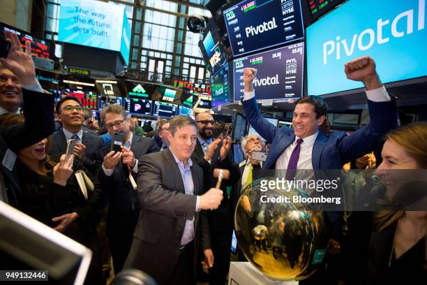 Rob Mee, chief executive officer of Pivotal Software Inc., center, rings a ceremonial bell with Tom Farley, president of the NYSE Group Inc., second...