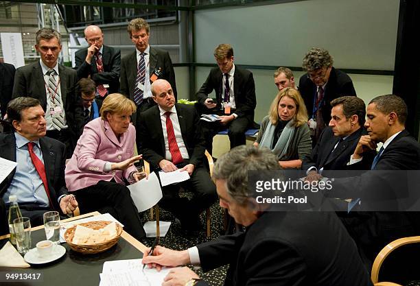 German Chancellor Angela Merkel negotiates with president of the European Commission, Jose Manuel Barroso , Sweden's prime minister and standing...