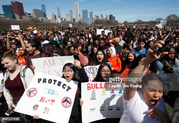 Students hold up their hands while taking part in National School Walkout Day to protest school violence on April 20, 2018 in Chicago, Illinois....