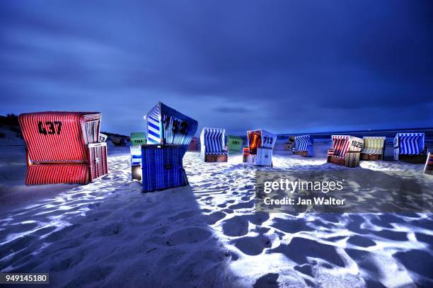 dramatically illuminated beach chairs at night, langeoog beach, east frisian islands, germany - langeoog stock pictures, royalty-free photos & images