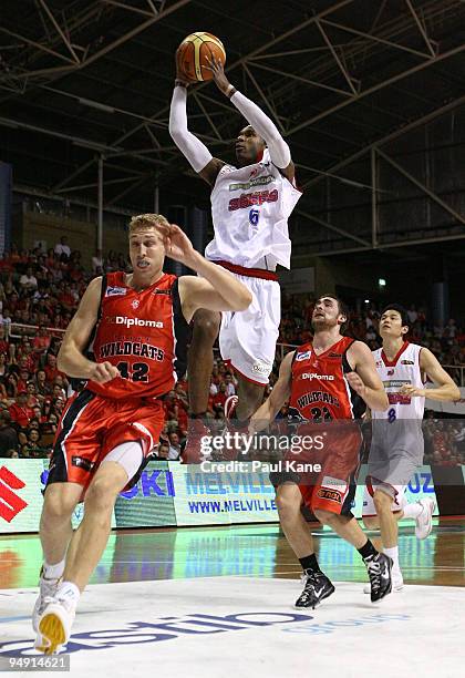 Cortez Groves of the 36'ers lays up over Shawn Redhage of the Wildcats during the round 13 NBL match between the Perth Wildcats and the Adelaide...