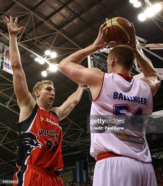 Adam Ballinger of the 36'ers looks to in-bound the ball past Shawn Redhage of the Wildcats during the round 13 NBL match between the Perth Wildcats...