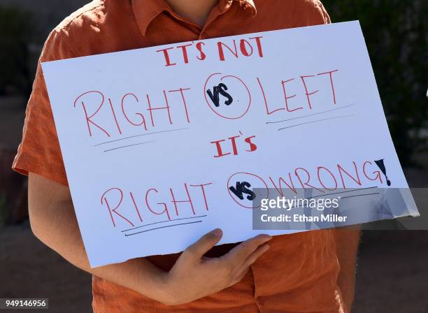 Palo Verde High School student Jake Grosvenor holds a sign outside the school as he participates in the National School Walkout on the 19th...
