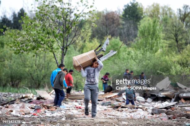 Residents collect items of value in the debris after homes were razed in a Roma quarter of Sofia. At least 20 homes, deemed illegal were destroyed by...