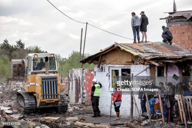 Residents watch as bulldozers raze homes in the Roma quarter of Sofia. At least 20 homes, deemed illegal were destroyed by the local municipality,...