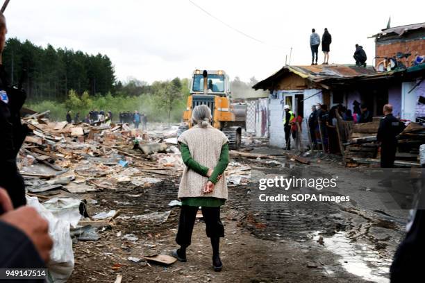 Resident watches as her home and others are razed in a Roma quarter of Sofia. At least 20 homes, deemed illegal were destroyed by the local...