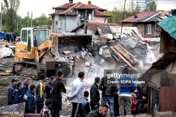 Residents watch as bulldozers raze homes in the Roma quarter of Sofia. At least 20 homes, deemed illegal were destroyed by the local municipality,...