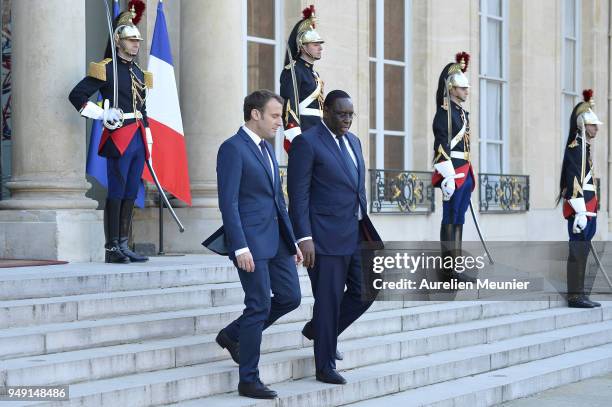 French President Emmanuel Macron escorts Senegal President Macky Sall after a meeting at Elysee Palace on April 20, 2018 in Paris, France. Senegal...