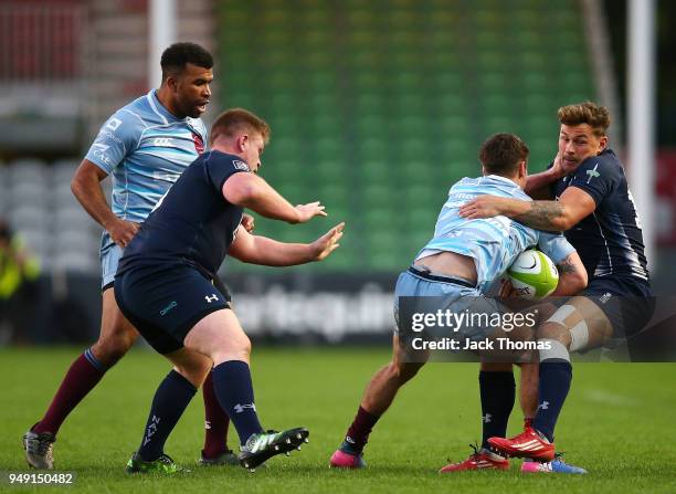 Flt Lt Lloyd Owen of the Royal Air Force Seniors is tackled by ET Eldon Meyers of the Royal Navy Senior XV at Twickenham Stoop on April 20, 2018 in...