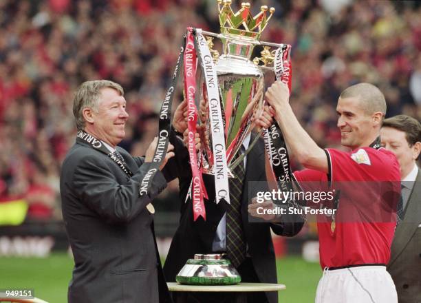 Manchester United manager Alex Ferguson lifts the league trophy with his captain Roy Keane of Manchester United after the FA Carling Premiership...