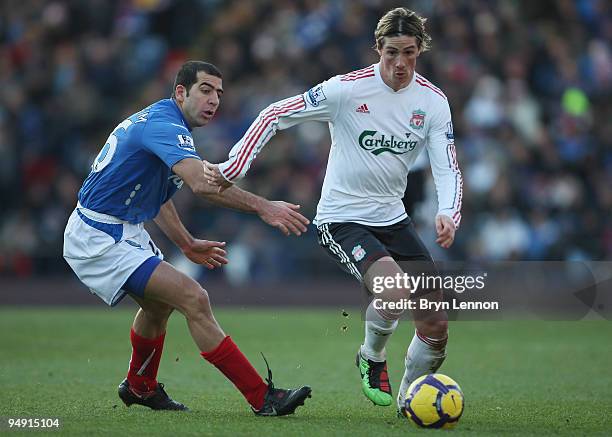 Fernando Torres of Liverpool goes past Tal Ben Haim of Portsmouth during the Barclays Premier League match between Portsmouth and Liverpool at...