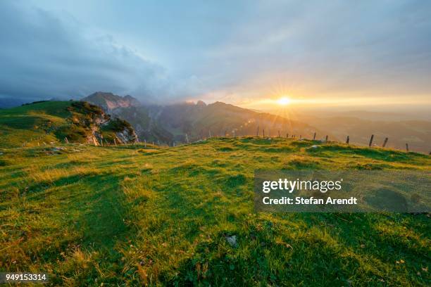 dramatic sunset with cloudy skies in the mountains on the alpsigel in alpstein, bruelisau, appenzell innerrhoden, switzerland - appenzell innerrhoden stock pictures, royalty-free photos & images