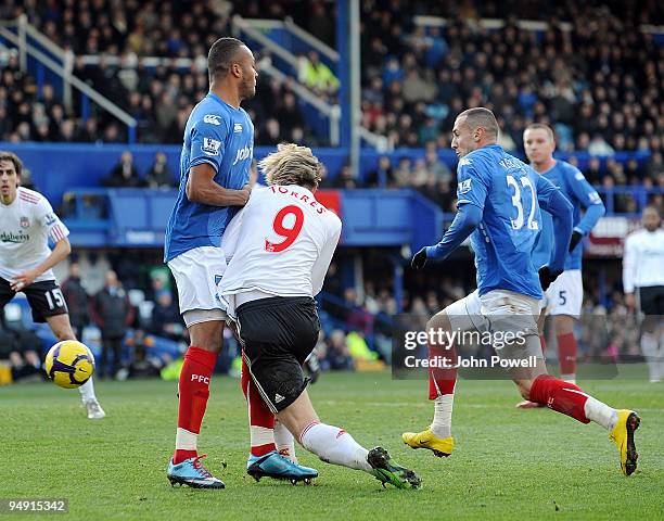 Fernando Torres of Liverpool stopped dead in the box by Younes Kaboul of Portsmouth during the Barclays Premier League match between Portsmouth and...