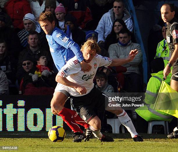 Dirk Kuyt of Liverpool battles with Hermann Hreidarsson of Portsmouth during the Barclays Premier League match between Portsmouth and Liverpool at...