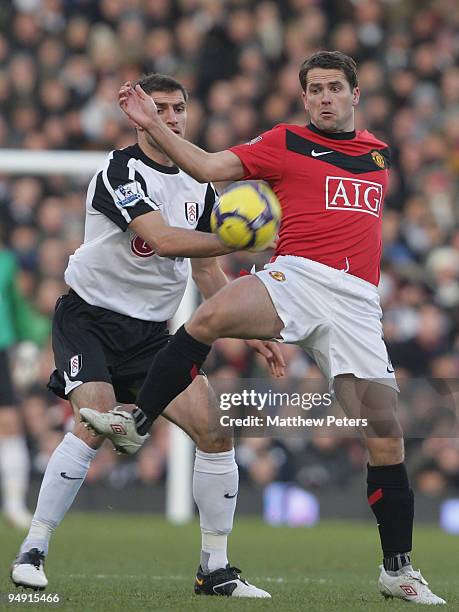 Michael Owen of Manchester United clashes with Aaron Hughes of Fulham during the FA Barclays Premier League match between Fulham and Manchester...