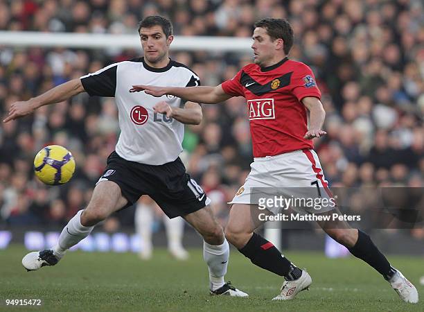 Michael Owen of Manchester United clashes with Aaron Hughes of Fulham during the FA Barclays Premier League match between Fulham and Manchester...