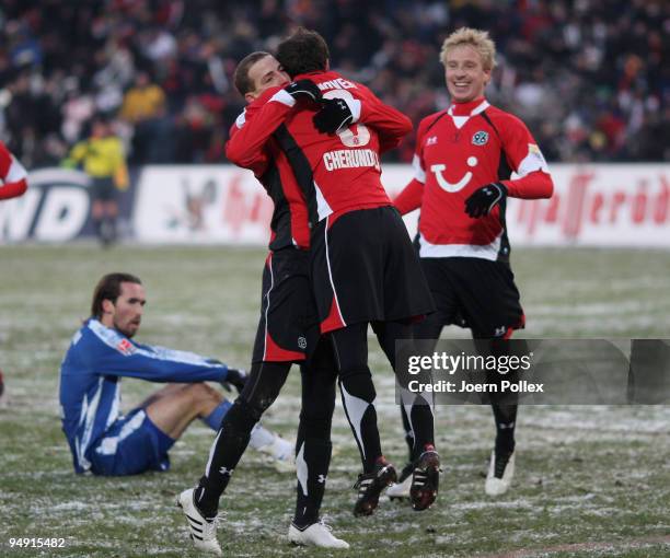 Jan Schlaudraff of Hanover celebrates with his team mates Steven Cherundolo and Mike Hanke after scoring his teams second goal during the Bundesliga...