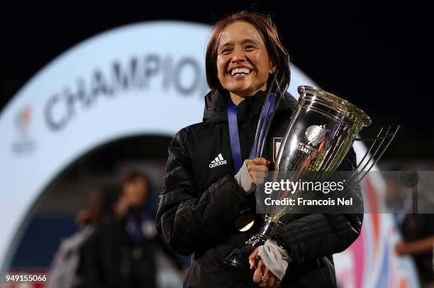Head coach of Japan, Asako Takemoto poses with the trophy after winning the AFC Women's Asian Cup final between Japan and Australia at the Amman...