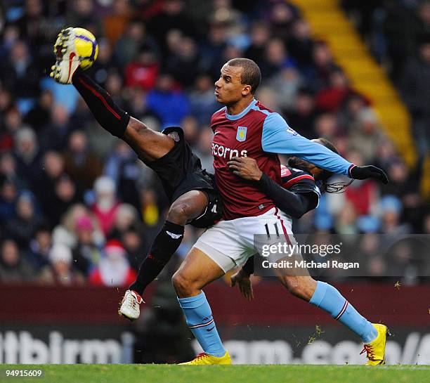 Gabriel Agbonlahor of Villa is tackled by Salif Diao of Stoke during the Barclays Premier League match between Aston Villa and Stoke City at Villa...