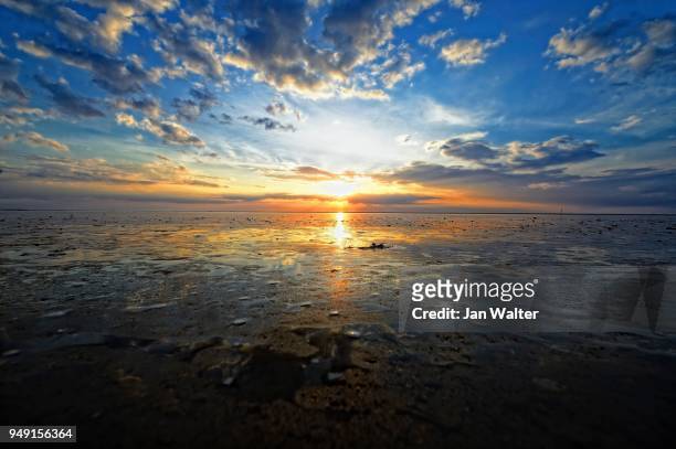 dramatic sunset on the beach, langeoog, east frisian islands, germany - langeoog stock pictures, royalty-free photos & images