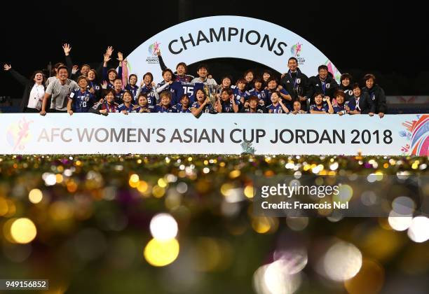 Players of Japan pose with the trophy after winning the AFC Women's Asian Cup final between Japan and Australia at the Amman International Stadium on...