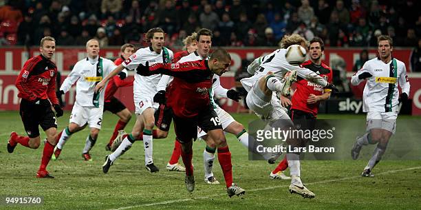 Eren Derdiyok of Leverkusen heads the ball next to Tobias Levels of Moenchengladbach during the Bundesliga match between Bayer Leverkusen and...